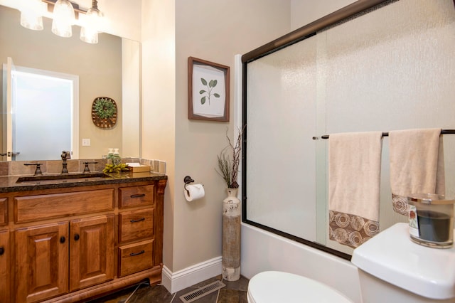 full bathroom with bath / shower combo with glass door, vanity, and toilet