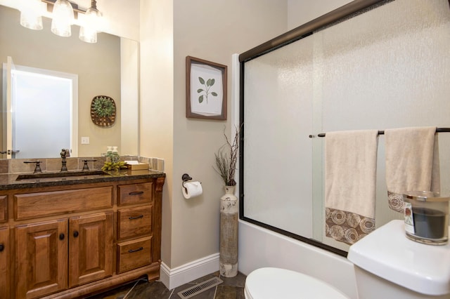 full bathroom featuring vanity, baseboards, enclosed tub / shower combo, toilet, and visible vents