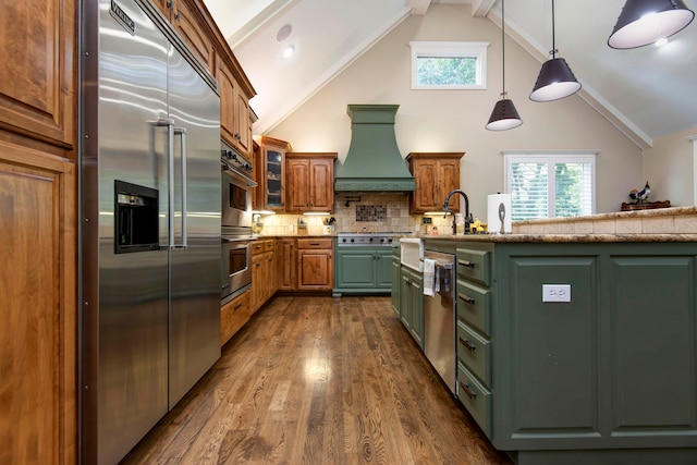 kitchen with lofted ceiling with beams, tasteful backsplash, custom range hood, stainless steel appliances, and dark hardwood / wood-style floors