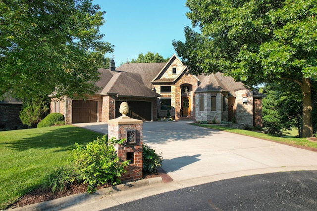 view of front facade featuring a front yard and a garage