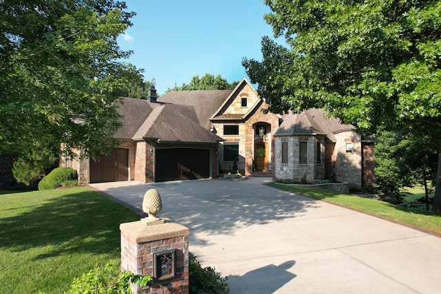 view of front facade featuring concrete driveway, a front lawn, stone siding, and a garage