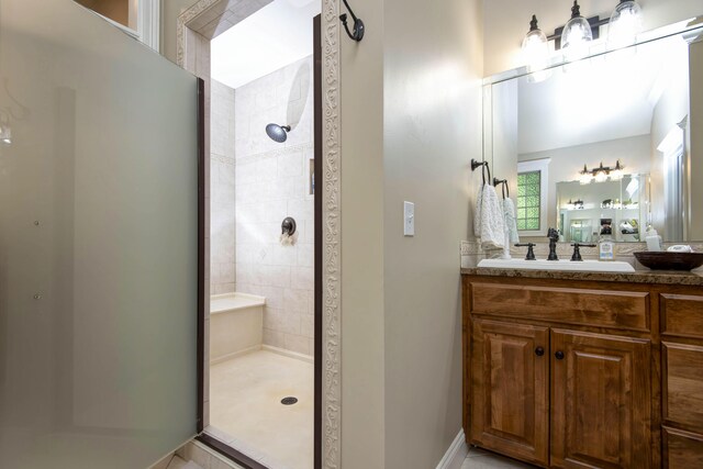 bathroom with vanity and a tile shower