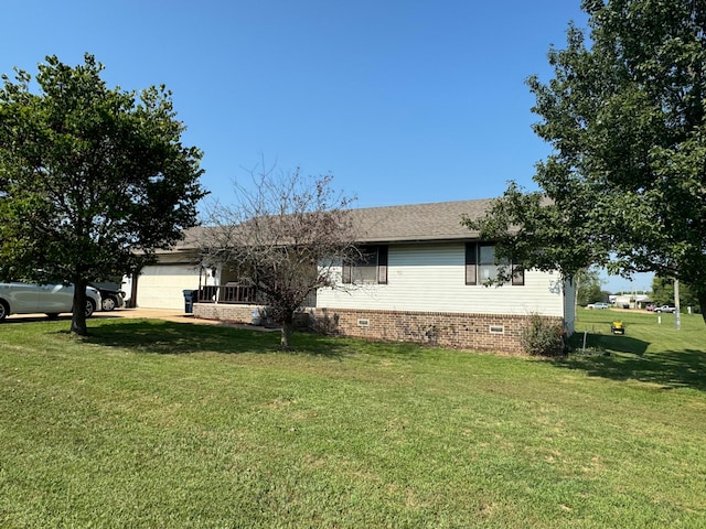 view of home's exterior with a garage and a lawn