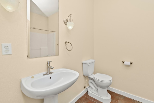 bathroom featuring tile patterned flooring, sink, and toilet