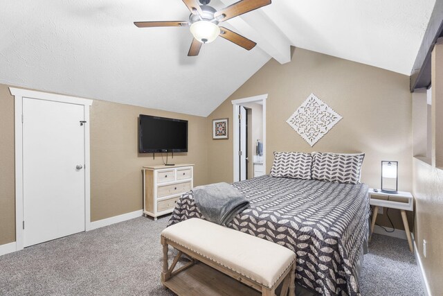 carpeted bedroom with ceiling fan and vaulted ceiling with beams