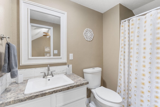 bathroom featuring vanity, toilet, curtained shower, a textured ceiling, and vaulted ceiling