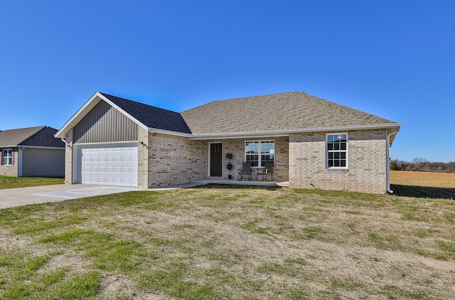 view of front facade featuring covered porch, a garage, and a front yard