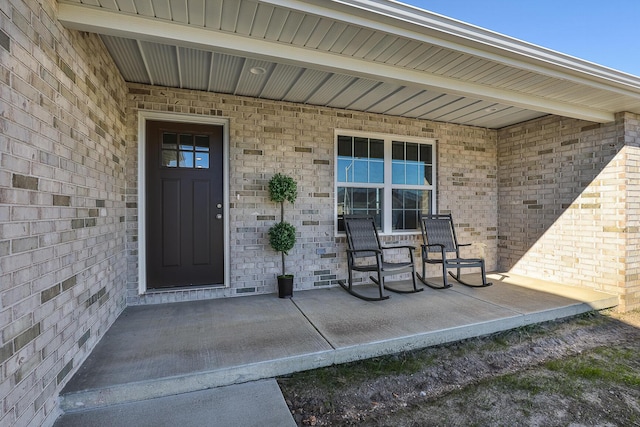 view of exterior entry featuring a porch