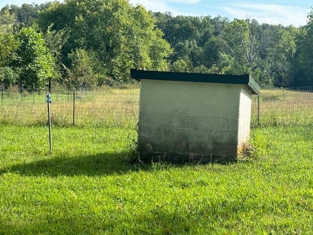 view of outbuilding featuring a lawn