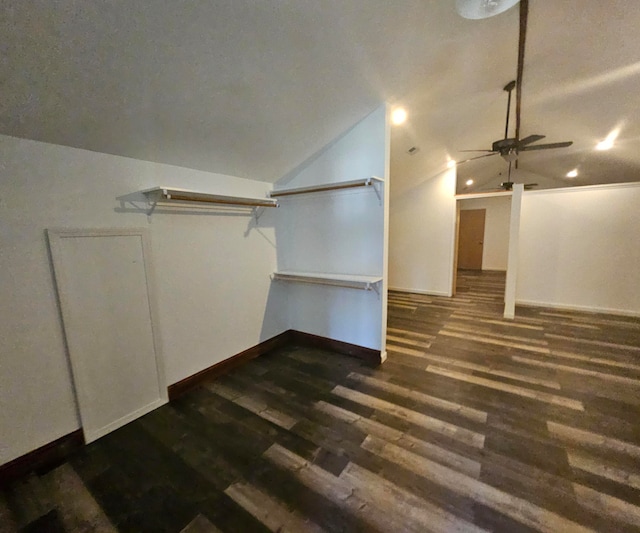 additional living space with vaulted ceiling, dark hardwood / wood-style flooring, and ceiling fan