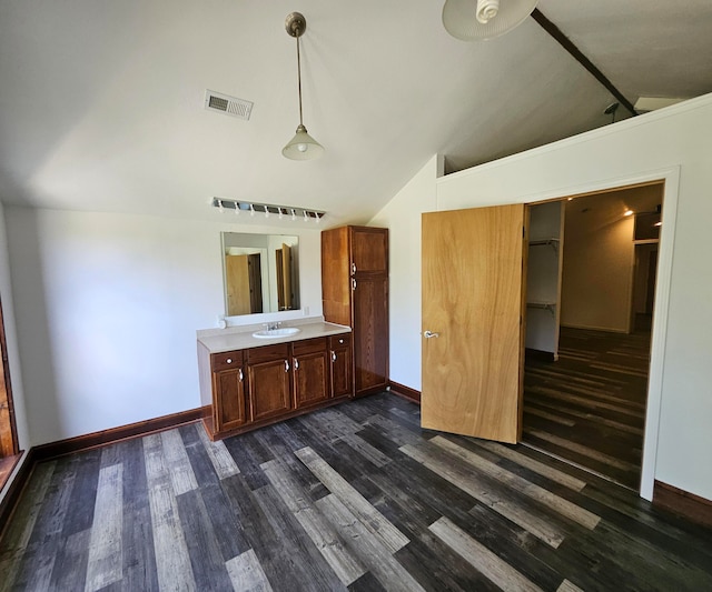 interior space with vanity, vaulted ceiling, and hardwood / wood-style flooring