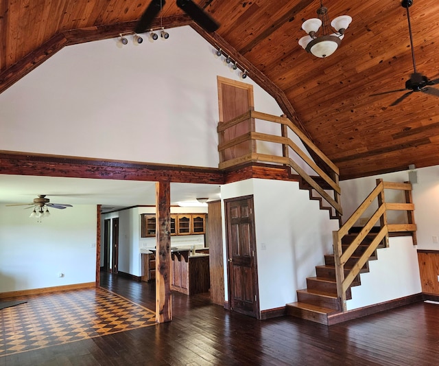 staircase with hardwood / wood-style flooring, a notable chandelier, vaulted ceiling with beams, and wooden ceiling