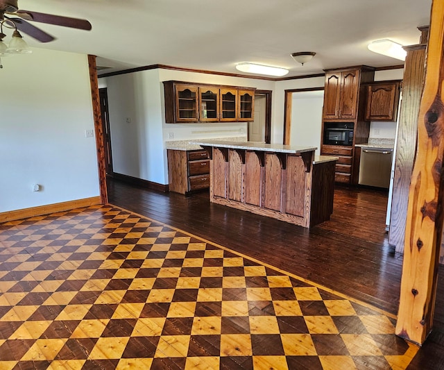 kitchen with a kitchen island, ceiling fan, dark hardwood / wood-style flooring, a kitchen breakfast bar, and dishwasher