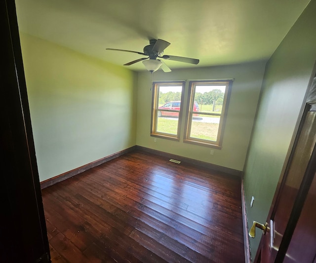 empty room featuring dark hardwood / wood-style floors and ceiling fan