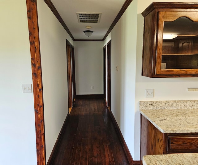 corridor featuring crown molding and dark hardwood / wood-style flooring