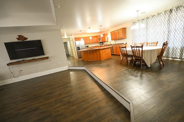 dining room featuring an inviting chandelier, baseboards, and dark wood-type flooring