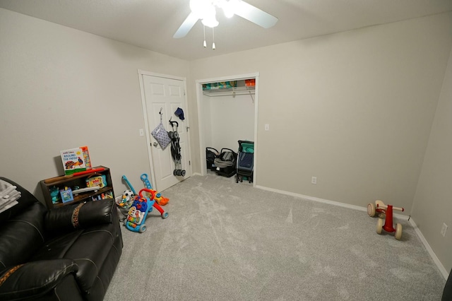 rec room with a ceiling fan, carpet, and baseboards