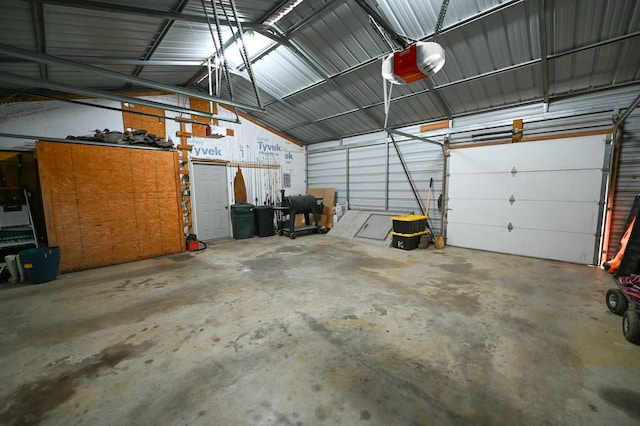 garage with a garage door opener and metal wall