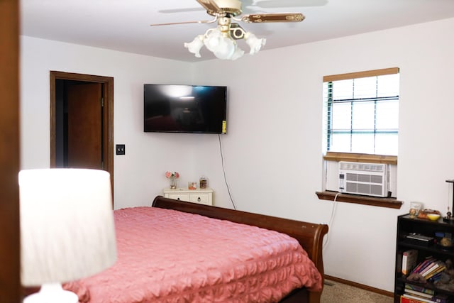 bedroom with cooling unit, carpet floors, baseboards, and ceiling fan