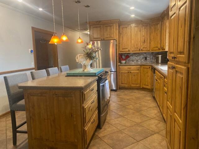 kitchen featuring pendant lighting, a breakfast bar area, a center island, and stainless steel appliances