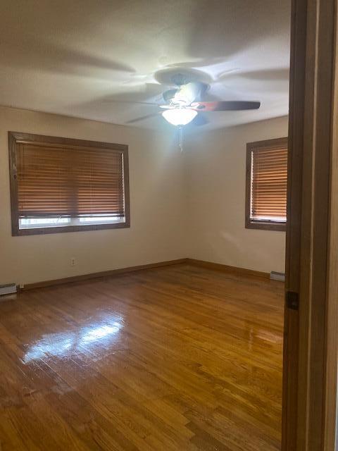 unfurnished room featuring hardwood / wood-style flooring and ceiling fan