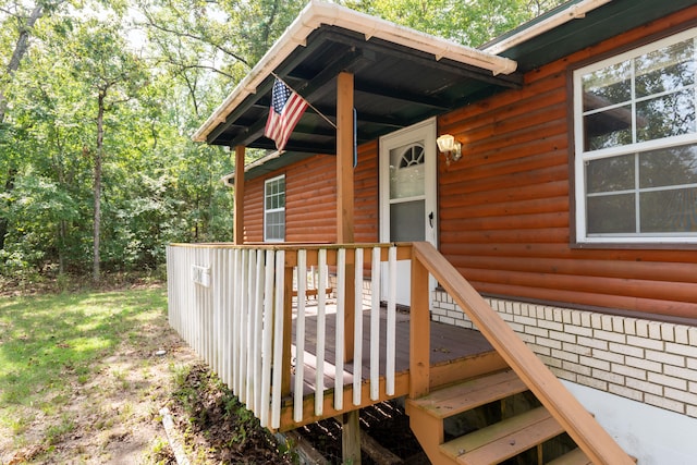 view of exterior entry with a deck