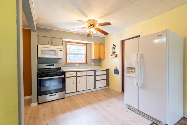 kitchen with light wood-type flooring, ceiling fan, and white appliances