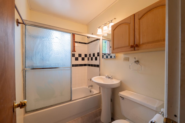 bathroom with combined bath / shower with glass door, crown molding, and toilet