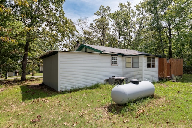 back of house featuring a yard and central AC