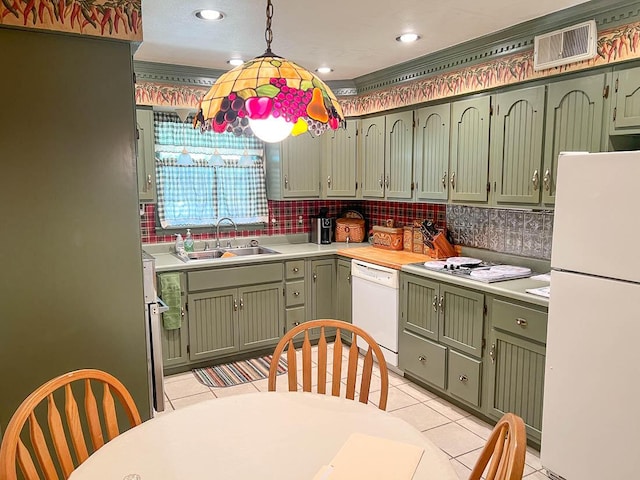 kitchen with visible vents, green cabinetry, a sink, and white appliances