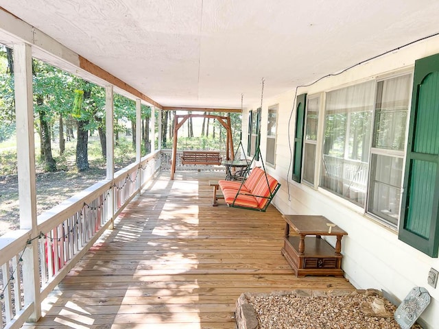 unfurnished sunroom featuring hardwood / wood-style flooring