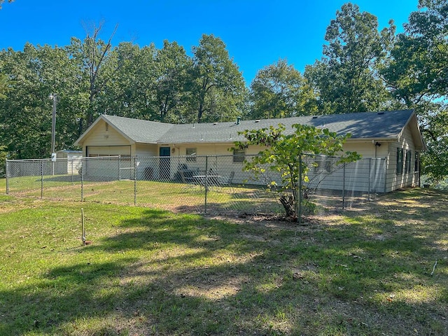 ranch-style home with a garage, a front yard, and fence