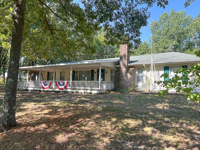 view of front of property featuring a porch and a chimney