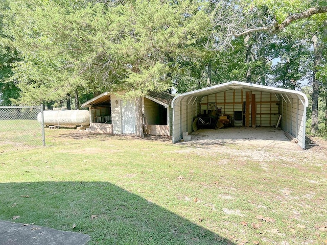 view of outdoor structure featuring fence and a carport