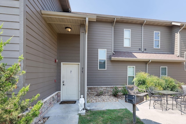 property entrance featuring a patio