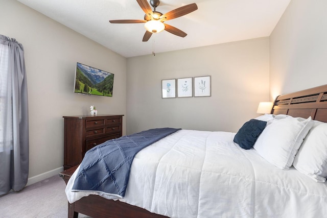 carpeted bedroom featuring baseboards and ceiling fan