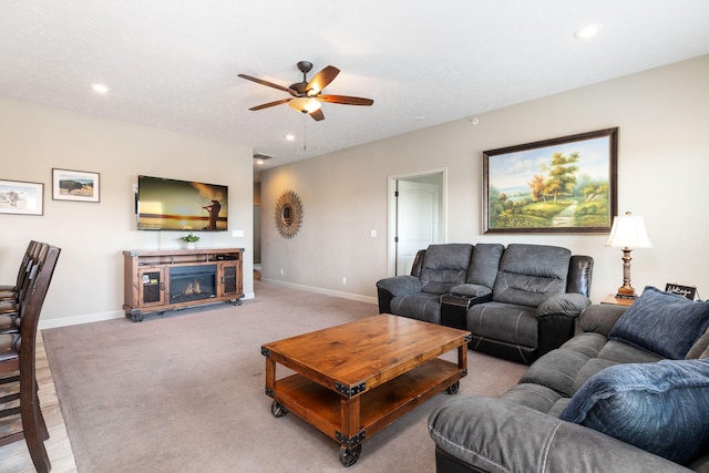 living room featuring ceiling fan and light hardwood / wood-style flooring