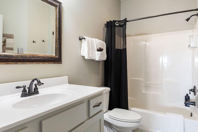 full bath featuring toilet, a textured wall, vanity, and shower / bath combo with shower curtain