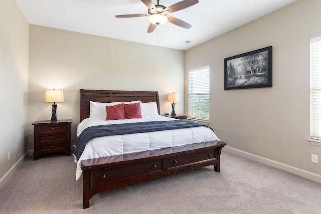bedroom featuring visible vents, baseboards, and light colored carpet