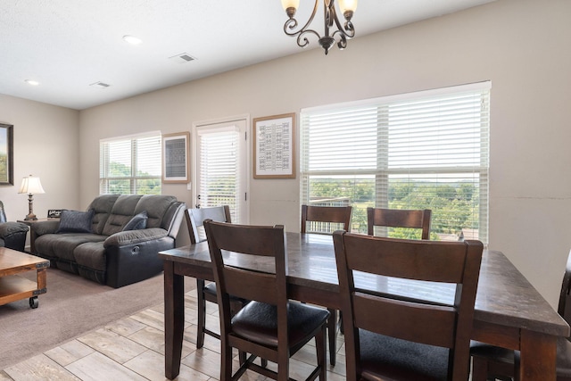 dining space featuring light wood-style floors, a chandelier, visible vents, and recessed lighting
