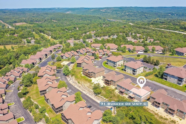 aerial view featuring a residential view and a wooded view