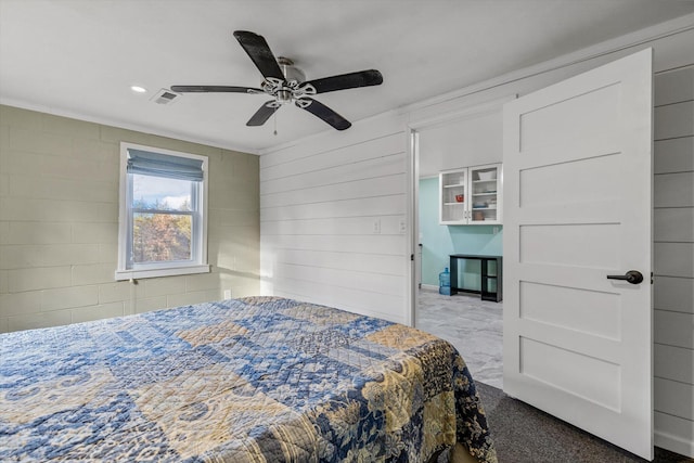 bedroom featuring ceiling fan, carpet floors, and crown molding