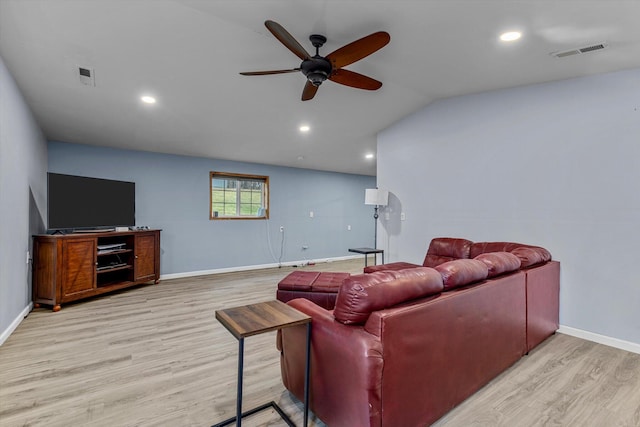 living room with light wood-type flooring, ceiling fan, and vaulted ceiling