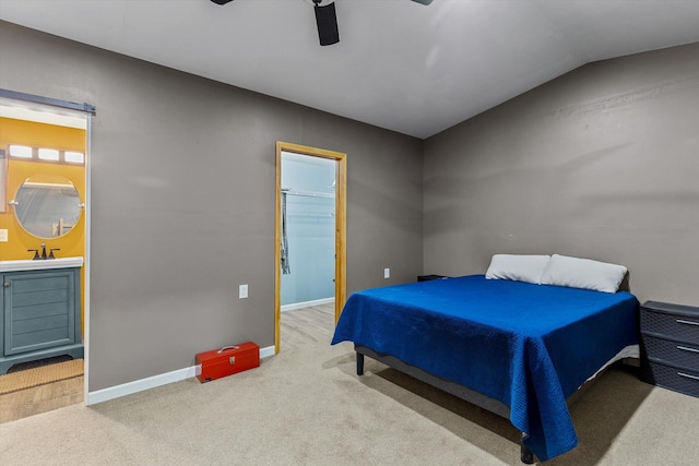 bedroom featuring carpet, ceiling fan, sink, lofted ceiling, and connected bathroom