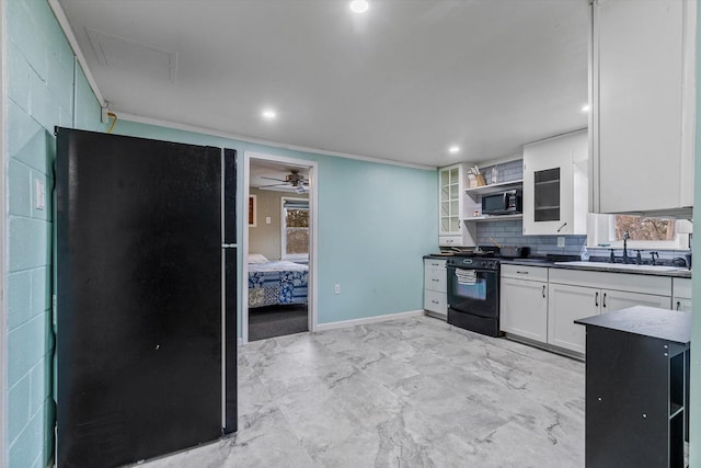 kitchen with ceiling fan, sink, decorative backsplash, black appliances, and white cabinetry