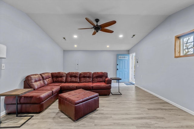 living room with ceiling fan, light hardwood / wood-style flooring, and vaulted ceiling