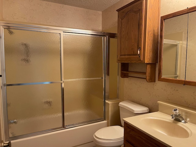 full bathroom featuring toilet, enclosed tub / shower combo, vanity, and a textured ceiling