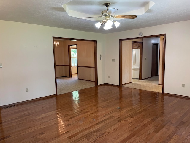 unfurnished room with light hardwood / wood-style floors, a textured ceiling, and ceiling fan