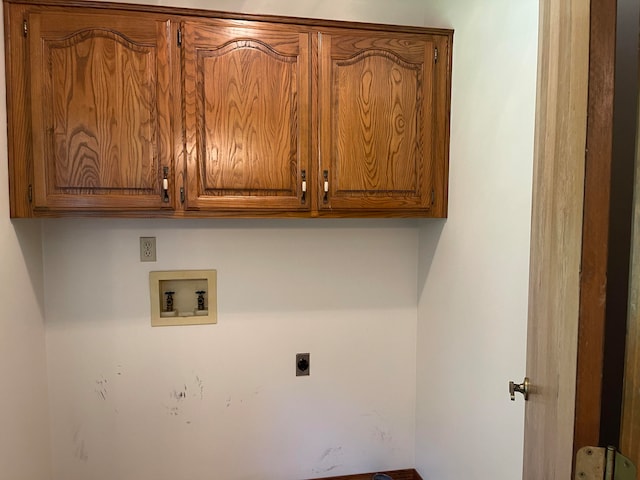 laundry room featuring hookup for a washing machine, hookup for an electric dryer, and cabinets