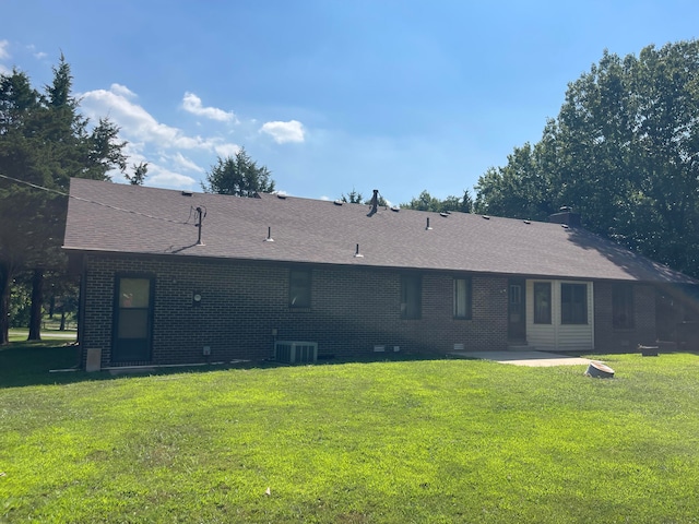 rear view of house featuring a lawn and a patio